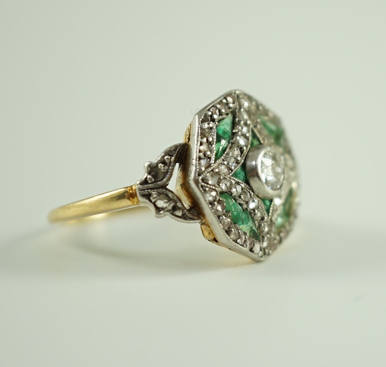 A Belle Epoque gold, emerald and diamond cluster set octagonal dress ring